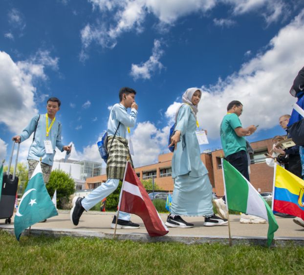 students walking past global flags