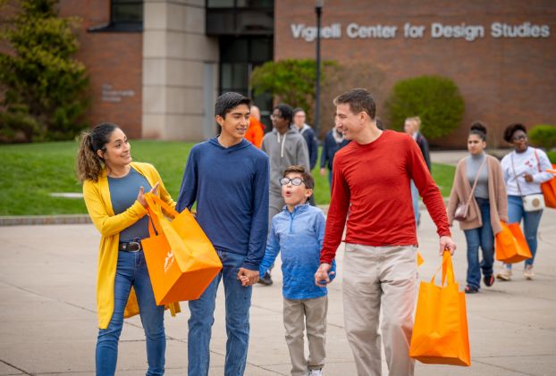 Family walking through the R I T campus together