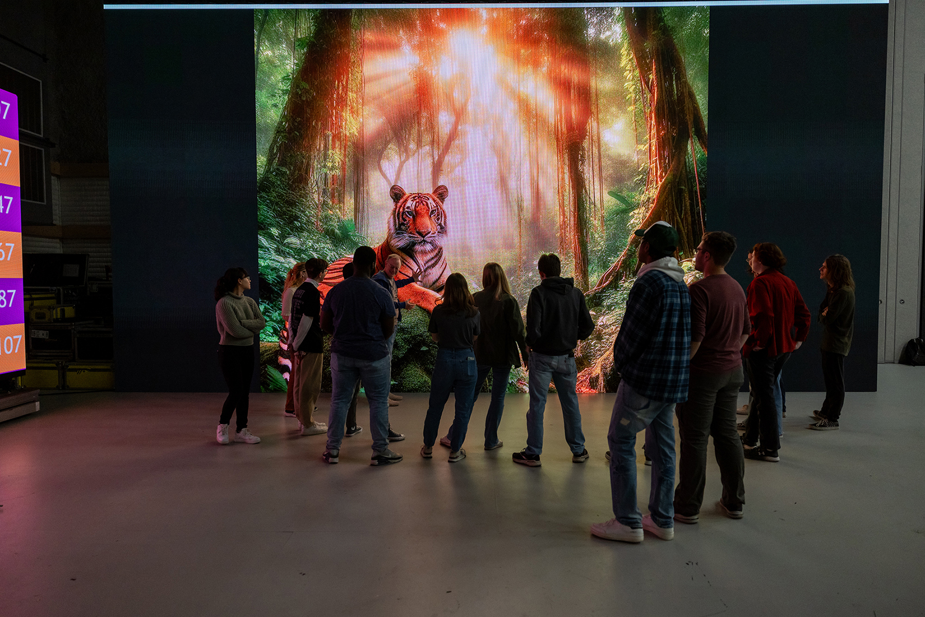A group of student use a virtual production screen in the MAGIC Spell Studios soundstage.