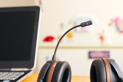 headset on desk with open laptop in background