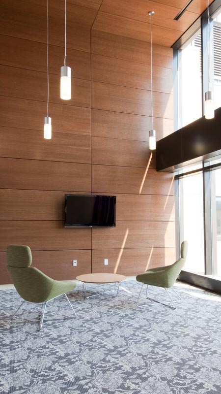 Indoor living space with green chairs and wooden walls