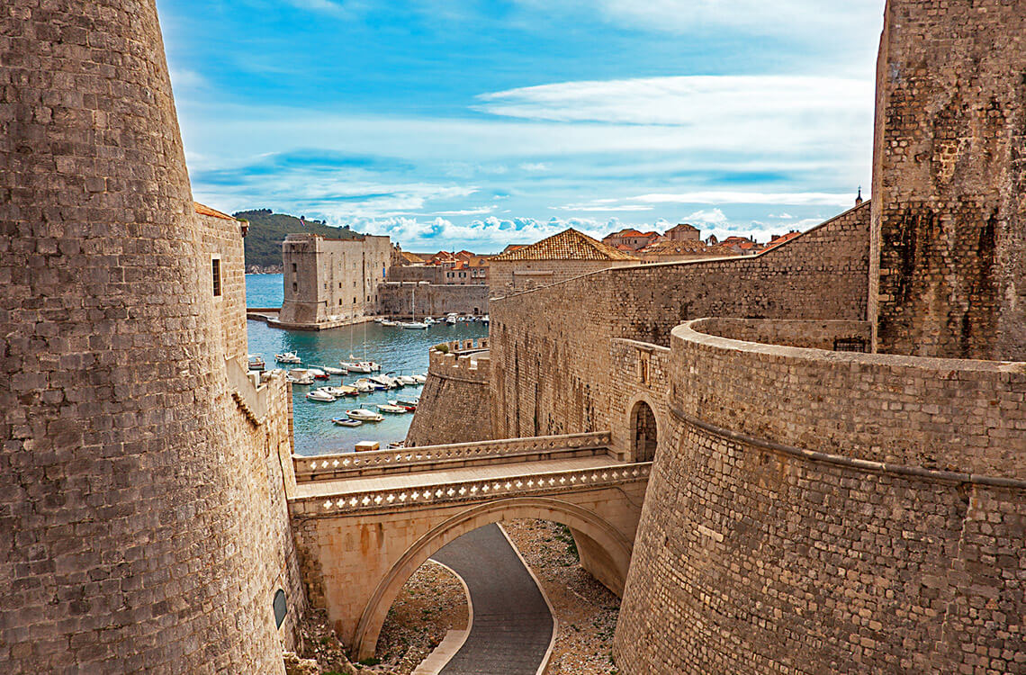View of a harbor between two stone buildings